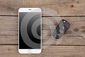 Car security concept - key with remote alarm control and smartphone