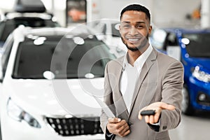 Car Seller Manager Offering Auto Key In Dealership Showroom