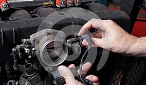 Car service - Engine repair  mechanic hands wiring terminal