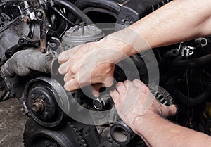 Car service - Engine repair mechanic hands with wrench  generator nut