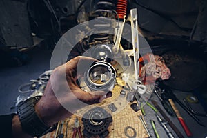 Car service from the first person mechanic. Male hands. Repair of the front wheel hub, replacement of Main wheel bearing,