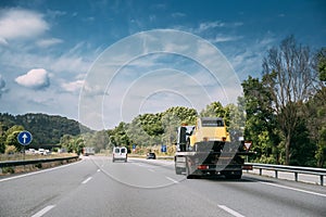 Car Service Transportation Concept. Tow Truck Transporting Retro Car On Motorway Freeway Highway. Help On Road