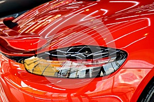 Car service worker applying nano coating on a car detail