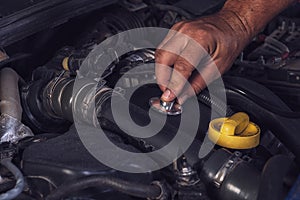 Car service worker diagnoses car breakdown