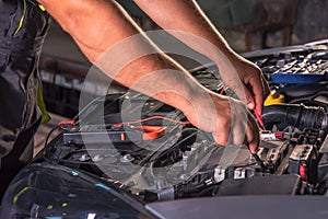 Car service worker diagnoses car breakdown