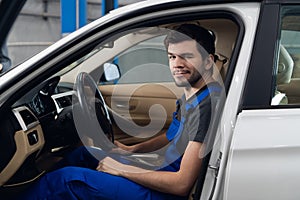 Car service worker sitting in a car in the front seat