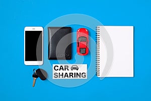 Car sharing concept. Composition with driver`s license, blank paper, toy car, car key and text sign `CAR SHARING`