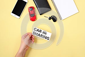 Car sharing concept. Human hand holding text sign