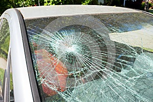 Car with a shattered windshield due to a violent break-in or accident