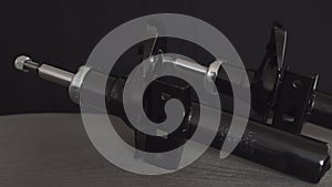 Car shock absorbers on a black background, close-up, equipment