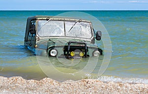 car is sinking in the sea
