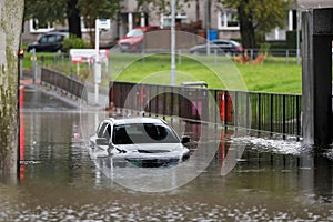 a car sits in the street after water was flooding it