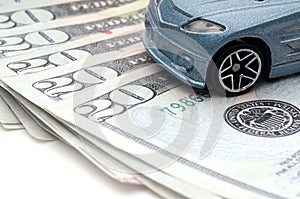 Car sitting on currency: new car loan