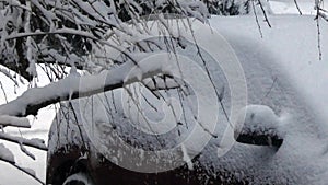 Car sitting in driveway under heavy fall of snow in winter