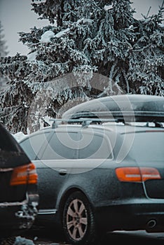 Car at the skiing resort. Wooden houses.