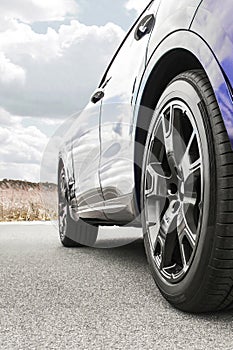 Car on sky background. Car wheels close up on a background of asphalt. Car tires. Car wheel close-up. for advertising