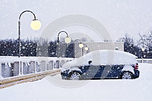 Car during a snowfall in town