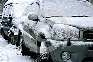 Car during a snowfall in town