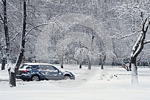 Car during a snowfall in town