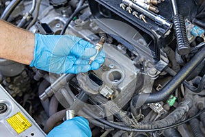 Car spark plug replacement. Repairing of vehicle.