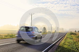 Car at Speed on Highway on Misty Summer Morning