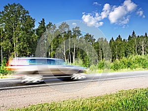 Car speeding on country highway,motion blur