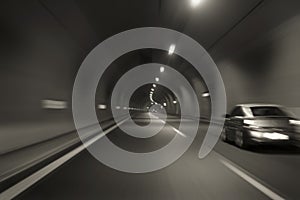 Car speeding through motorway tunnel motion blur