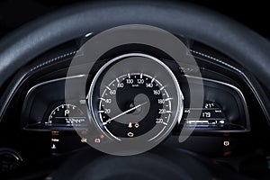 Car speedometer with kilometer per hour and tachometer,fuel meter,odometer and warning light on a car dashboard