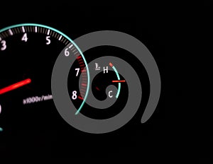 Car speedometer with a selective focus on a temperature gauge and blur background