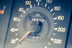 Car speedometer showing km/h with orange pointer