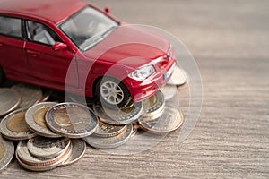 Car on stack of coins. Car loan, Finance, saving money, insurance and leasing time concepts