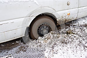 The car stalled in the mud in winter. minivan stalled in the mud. wrong, bad wheel tread for off road