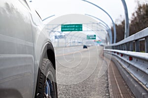 Car stand on wayside with side road view