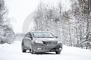 The car stands on a snow-covered road