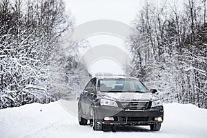 The car stands on a snow-covered road