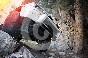 Car steering and suspension system of a 4x4 suv. Prepared Off-roader ran over a large stone lifestyle