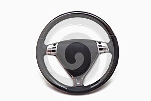 Car steering wheel with multi-function control buttons made of leather and carbon fiber on a white isolated background