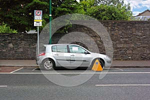 Car street clamped with metal wheel clamp