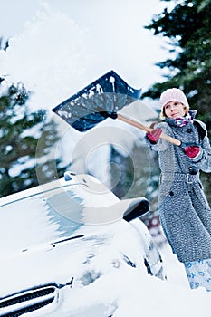 Car Stuck in the snow and a Woman Shoveling