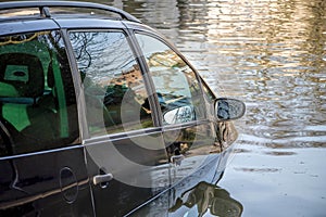 Car submerged in flood water.