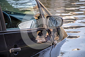 Car submerged in flood water.