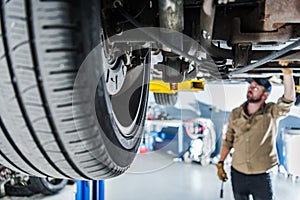 Car Suspension and Wheel Closeup From the Bottom