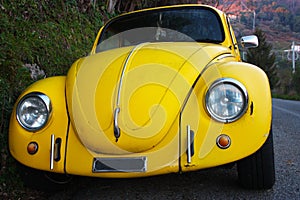Car symbol of a bygone era. vintage style car. old canary yellow transport system