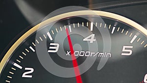 Car tachometer displaying engine speed in rpm