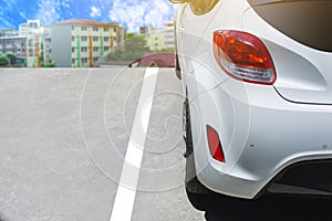 Car tail light red color white car on city and sky background. U