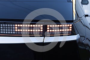 Car taillight. LED red taillight. Closeup tail light of a modern car. Rear light of a car. Rear lamp signals for turning