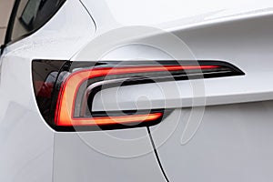 Car taillight. LED red taillight. Rear lamp signals for turning car on street. Closeup tail light of a modern car. Rear