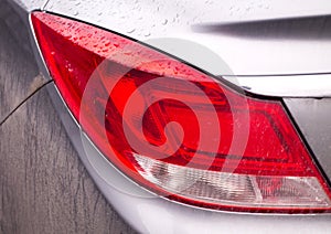 Car Taillight in Raindrops and Dirt