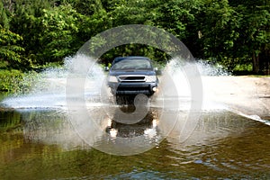 car testing specialist four wheel drive down the road in the forest to test the performance of the car