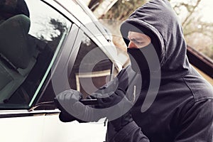 Car theft - thief trying to break into the vehicle